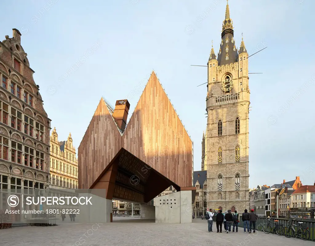 Ghent Market Hall, Ghent, Belgium. Architect: Robbrecht and Daem + Marie-Jose Van Hee, 2013. Elevation of Market Hall, urban square and great belfry.