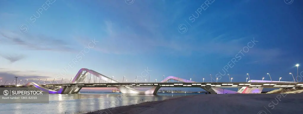 Sheikh Zayed Bridge,  Abu Dhabi, Abu Dhabi, United Arab Emirates. Architect: Zaha Hadid Architects, 2010. Grand panorama of illuminated waveform bridge structure spanning Maqta Channel.