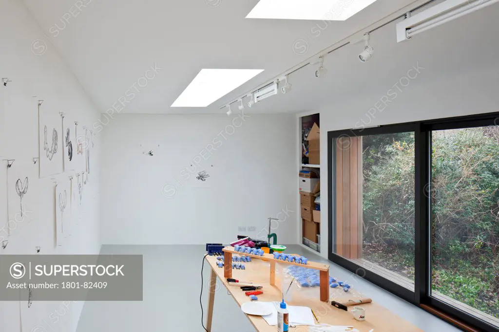 Ecospace Artist Studio Blackheath, London, United Kingdom. Architect: ecospace, 2012. Studio interior with artists desk and full-height window.