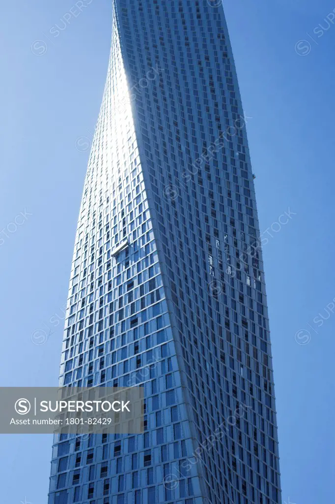 Infinity Tower, Dubai, United Arab Emirates. Architect: Skidmore, Owings and Merrill, 2013. Detail of 90 degree twist and titanium cladding with sun reflecting.
