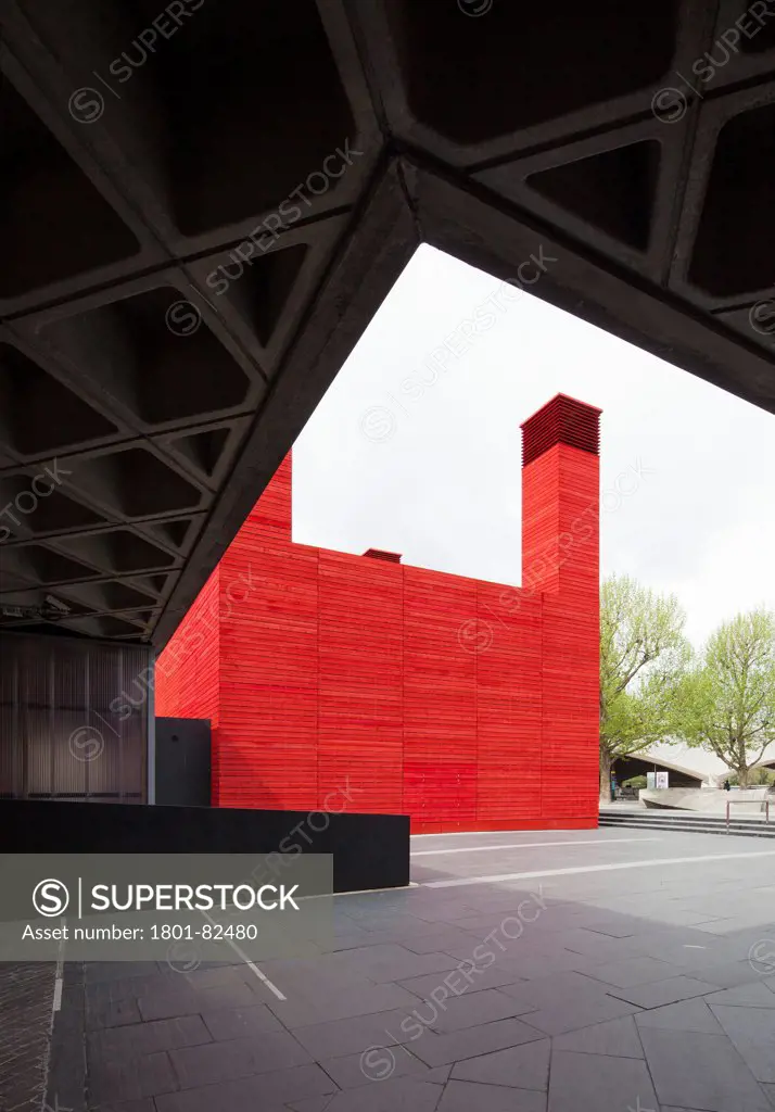 The Shed, London, United Kingdom. Architect: Haworth Tompkins Limited, 2013. View of The Shed looking from under the concrete coffering of the National Theatre.