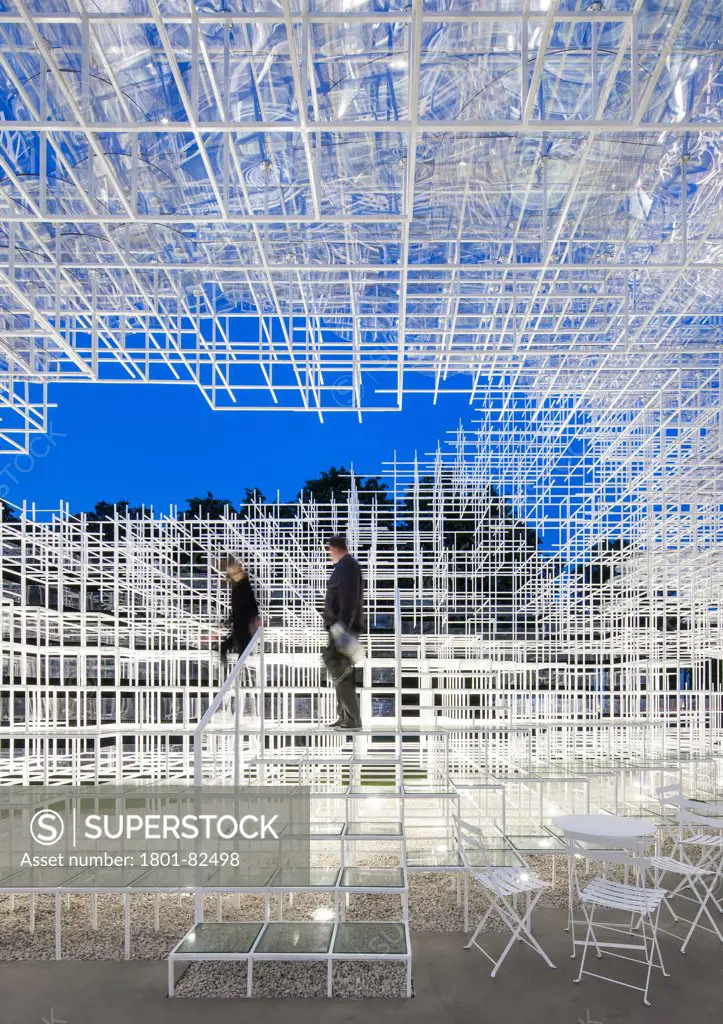 Serpentine Pavilion 2013, London, United Kingdom. Architect: Sou Fujimoto', 2013. Dusk view of a couple climbing down from the interior terraced seating.