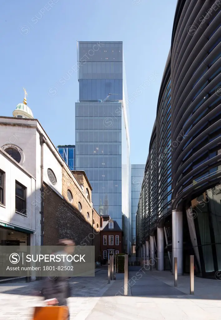 NEW COURT ROTHSCHILD BANK, London, United Kingdom. Architect: OMA WITH ALLIES and MORRISON, 2012. View of the Rothschild bank tower with a banker rushing past for a meeting. 21st century architecture juxtaposed with a medieval church.