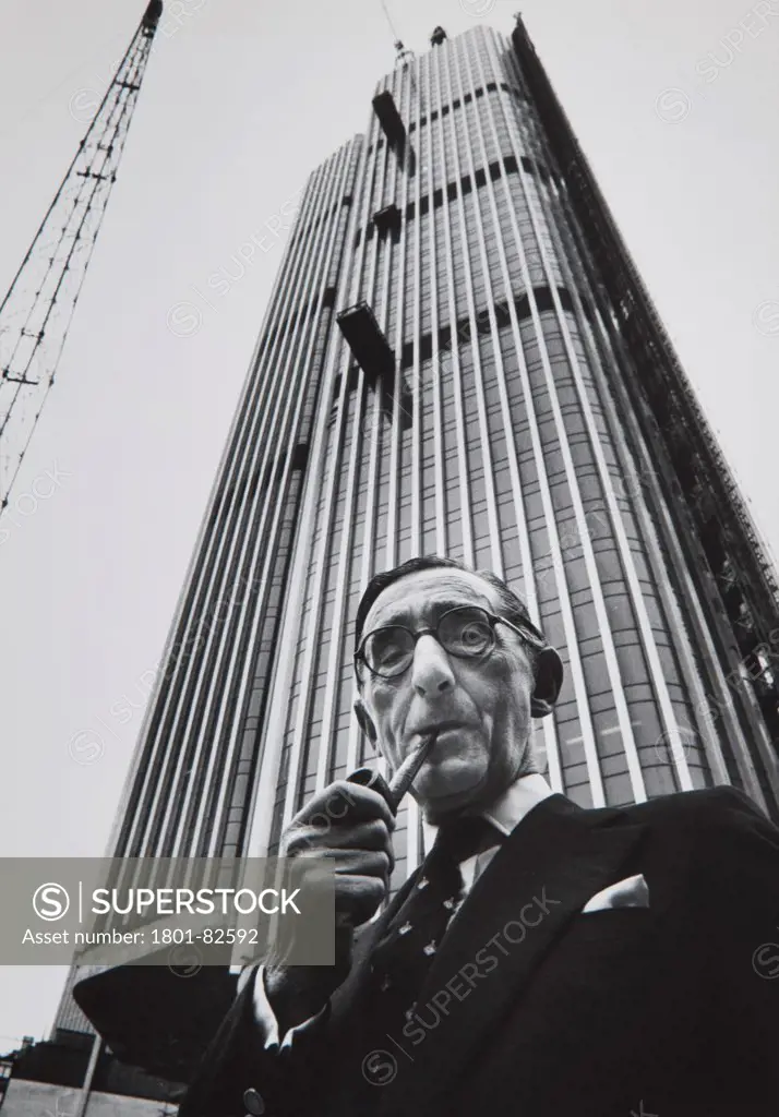 Architects' portraits by Anthony Weller, United Kingdom. Architect: Various. Richard (Reubin) Seifert at the Tower 42 under construction. Probably taken in 1970s.