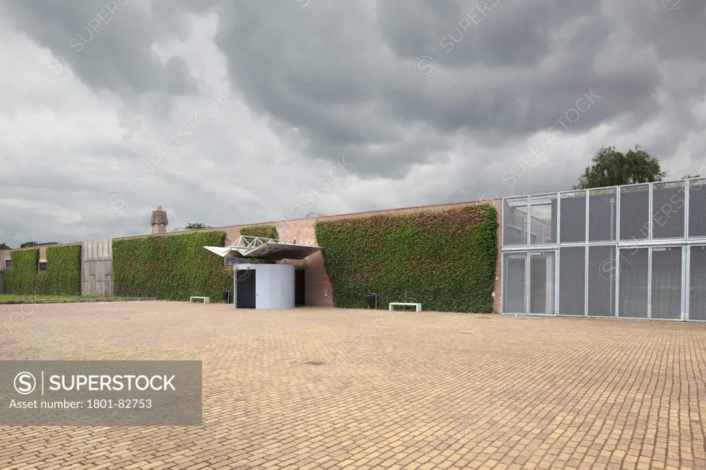 Main entrance with cobblestones against stormy sky, De Pont Museum of Contemporary Art, Tilburg, The Netherlands (architects: Benthem Crouwel Architekten)