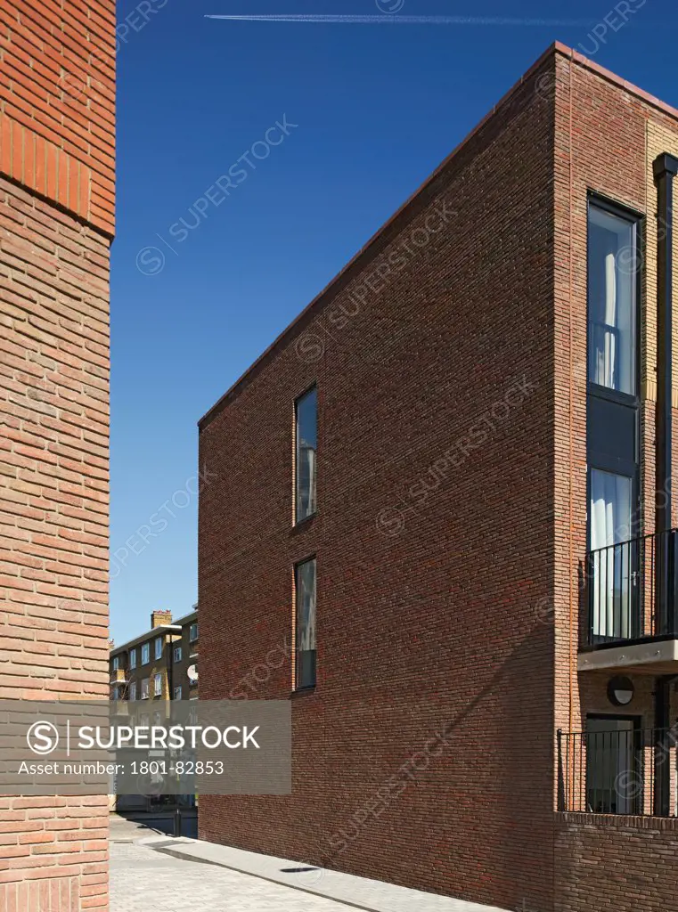 Library Street Affordable Housing, London, United Kingdom. Architect: Metaphorm Architects, 2012. Detail of two-tone brick cladding and oblong windows.