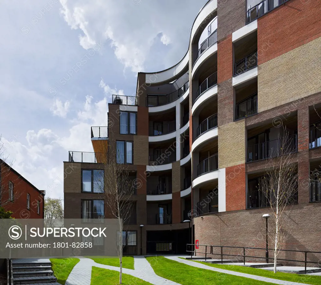 Library Street Affordable Housing, London, United Kingdom. Architect: Metaphorm Architects, 2012. Curved multi-storey brick facade with balconies.