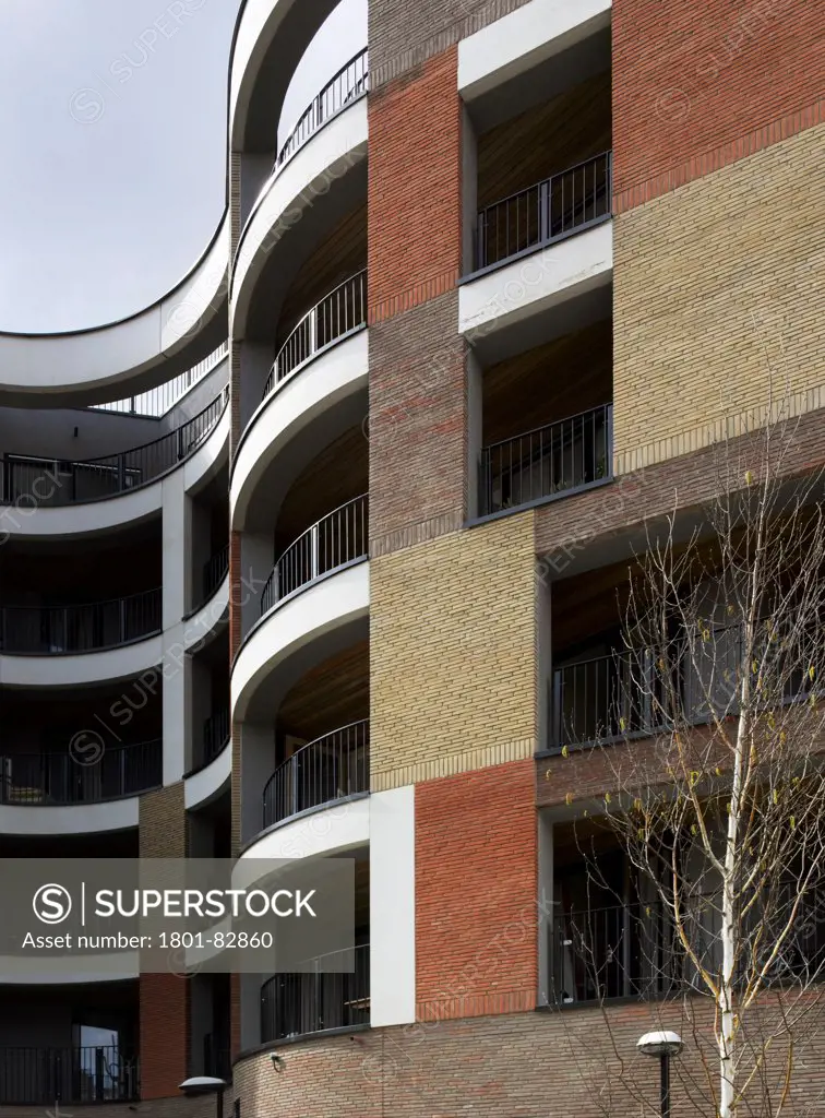Library Street Affordable Housing, London, United Kingdom. Architect: Metaphorm Architects, 2012. Detail of curved multi-storey brick facade with balconies.