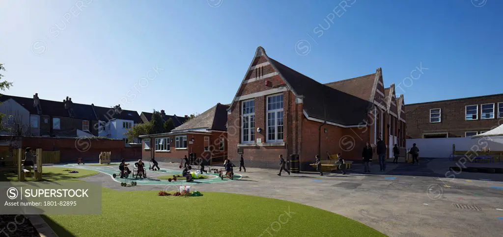 Davidson Centre Primary School, Croydon, United Kingdom. Architect: Architype Limited, 2012. Panorama of schoolyard and playground in context with Edwardian building.