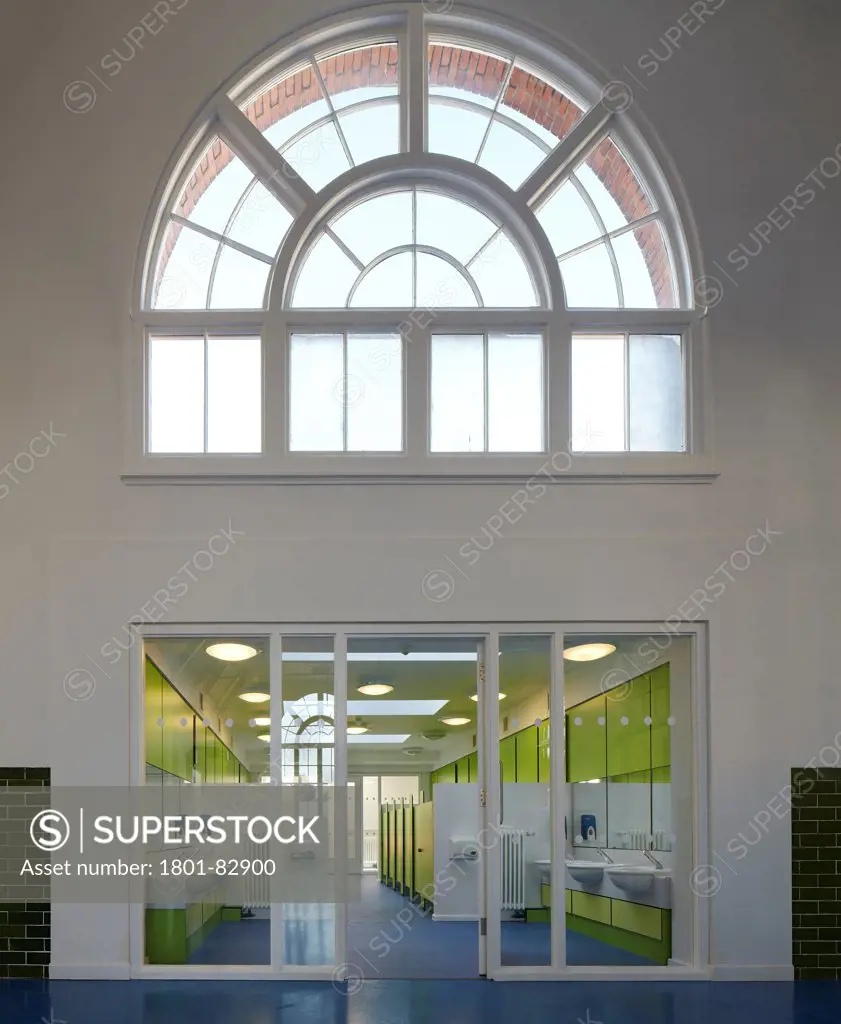 Davidson Centre Primary School, Croydon, United Kingdom. Architect: Architype Limited, 2012. Refurbished toilet area with large, arched Edwardian window above.