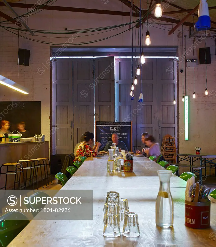 Camp and Furnace, Liverpool, United Kingdom. Architect: FWMA+ and Smiling Wolf, 2012. Details of plywood table in reception and eatery.