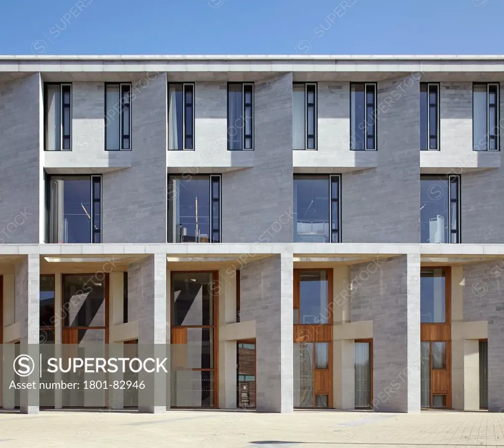 Medical School Building and Student Accommodation University Limerick, Limerick, Ireland. Architect: Grafton Architects, 2012. Front elevation of sunlit limestone facade.