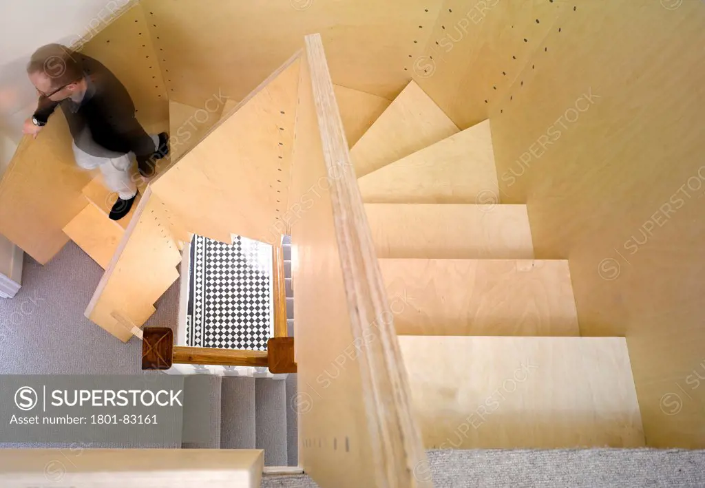 Farrer House, London, United Kingdom. Architect: West Architecture, 2013. Staircase view from top floor with blurred architect.