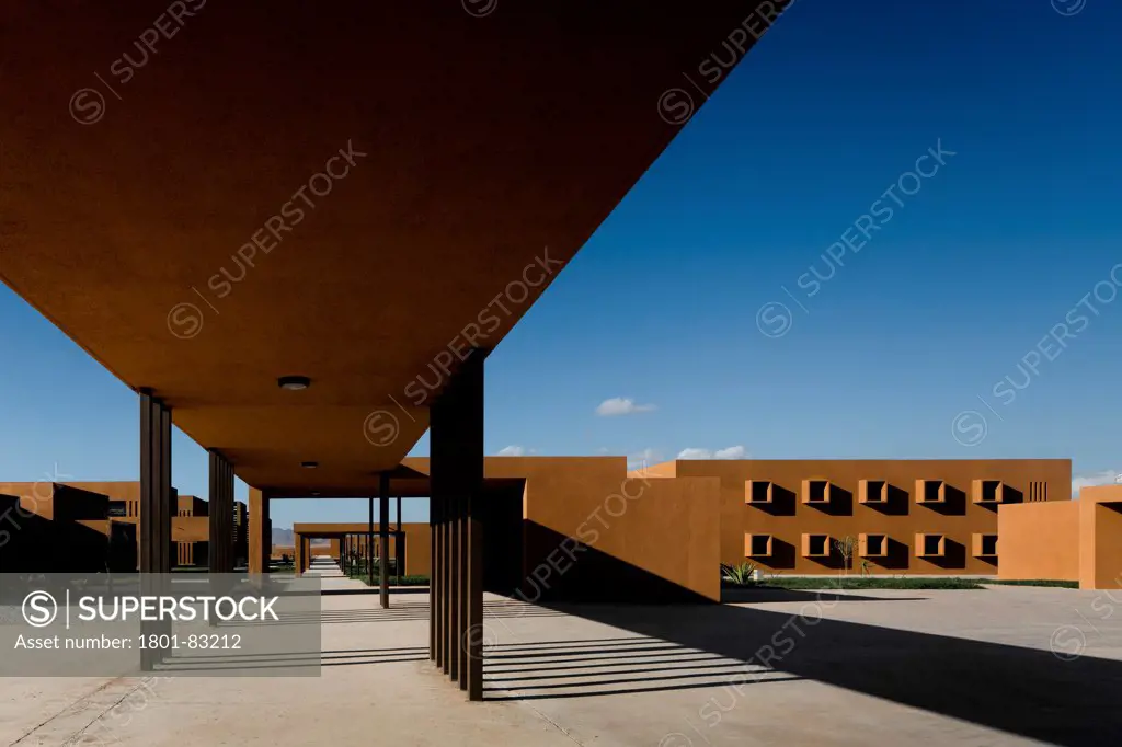 Technology School of Guelmim Morocco, Guelmim, Morocco. Architect: Saad El Kabbaj, Driss Kettani, Mohamed Amine Siana, 2011. Canopied walkways with buildings beyond.