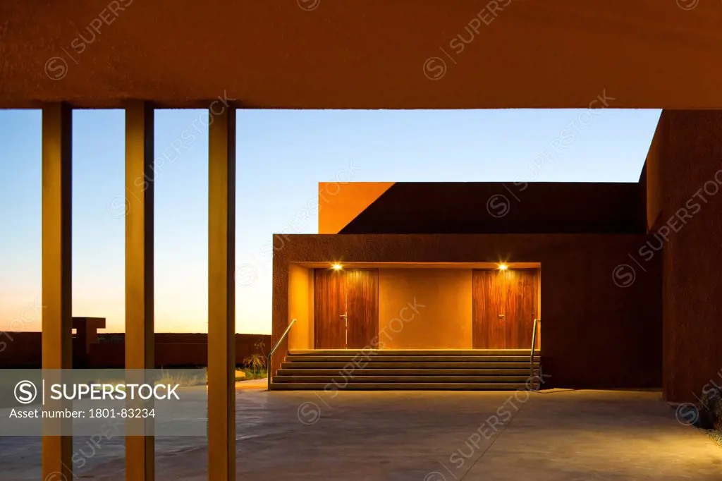 Technology School of Guelmim Morocco, Guelmim, Morocco. Architect: Saad El Kabbaj, Driss Kettani, Mohamed Amine Siana, 2011. View of building entrance at dusk.