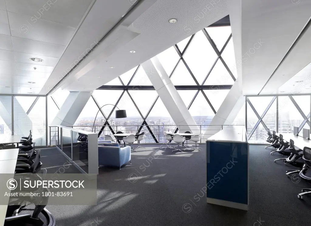 Office space at 30 St Mary Axe (the Gherkin), London, United Kingdom. Architect: Michael O'Sullivan, 2012. View towards break-out / seating area showing bespoke cabinets.