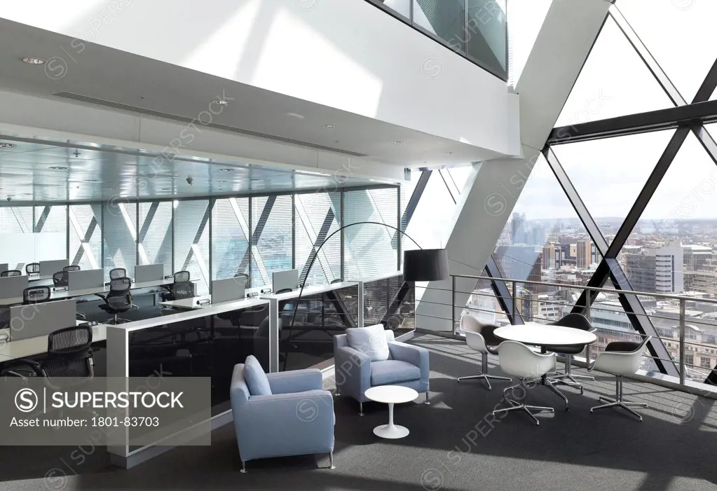Office space at 30 St Mary Axe (the Gherkin), London, United Kingdom. Architect: Michael O'Sullivan, 2012. Atrium seating / break-out space and bespoke cabinets with views over City of London.