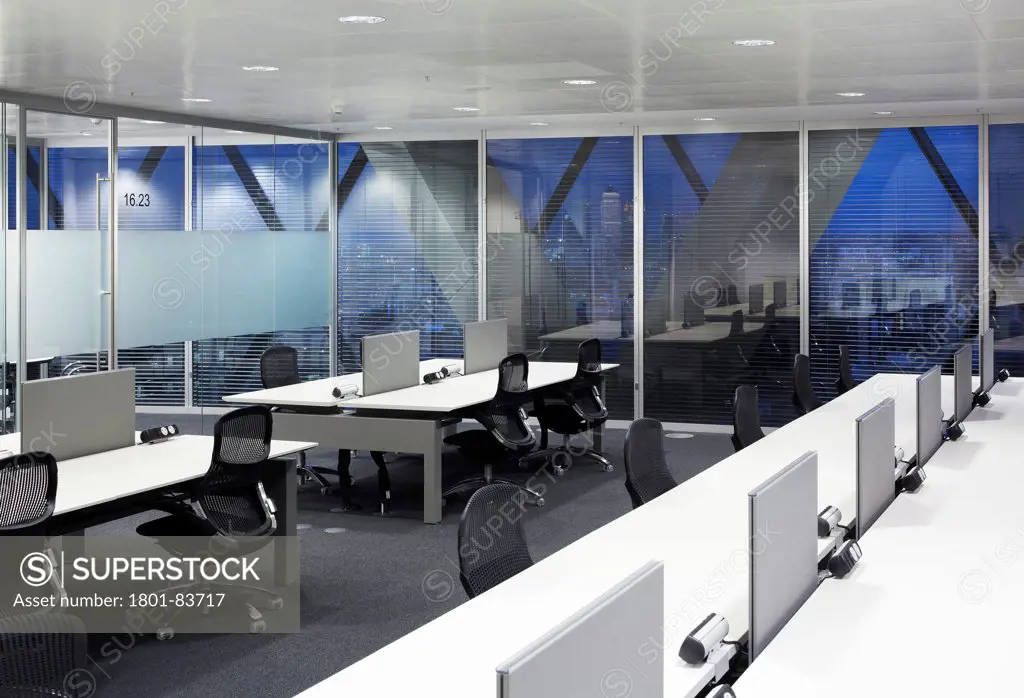 Office space at 30 St Mary Axe (the Gherkin), London, United Kingdom. Architect: Michael O'Sullivan, 2012. Dusk view of the open office area and meeting spaces.