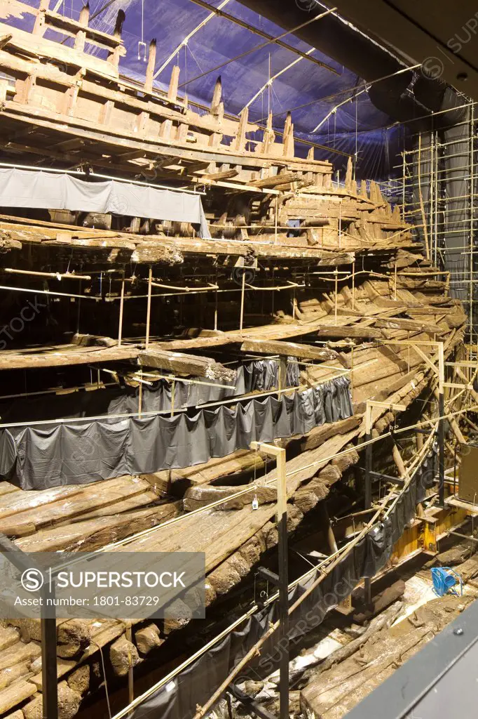The Mary Rose Museum, Portsmouth, United Kingdom. Architect: Wilkinson Eyre Architects , 2013. Internal view of Mary Rose through viewing window.