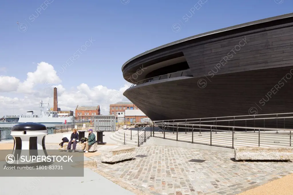 The Mary Rose Museum, Portsmouth, United Kingdom. Architect: Wilkinson Eyre Architects , 2013. External view of museum with Portsmouth Navel base in background.