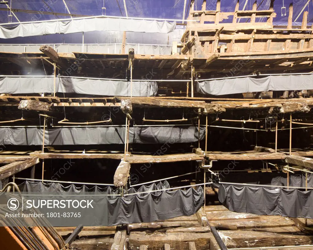 The Mary Rose Museum, Portsmouth, United Kingdom. Architect: Wilkinson Eyre Architects , 2013. Internal view of Mary Rose in a state of drying.