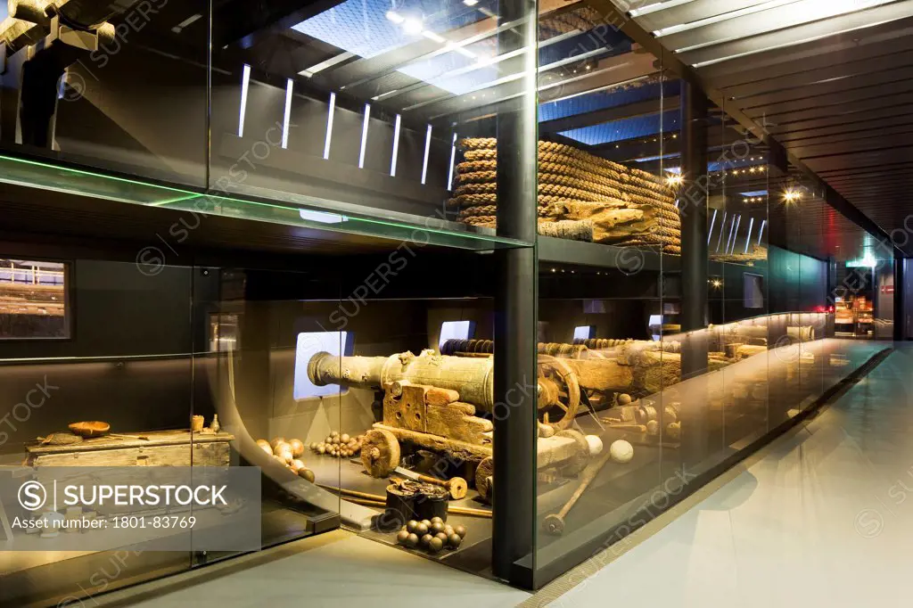 The Mary Rose Museum, Portsmouth, United Kingdom. Architect: Wilkinson Eyre Architects , 2013. Internal view of display case with canons.