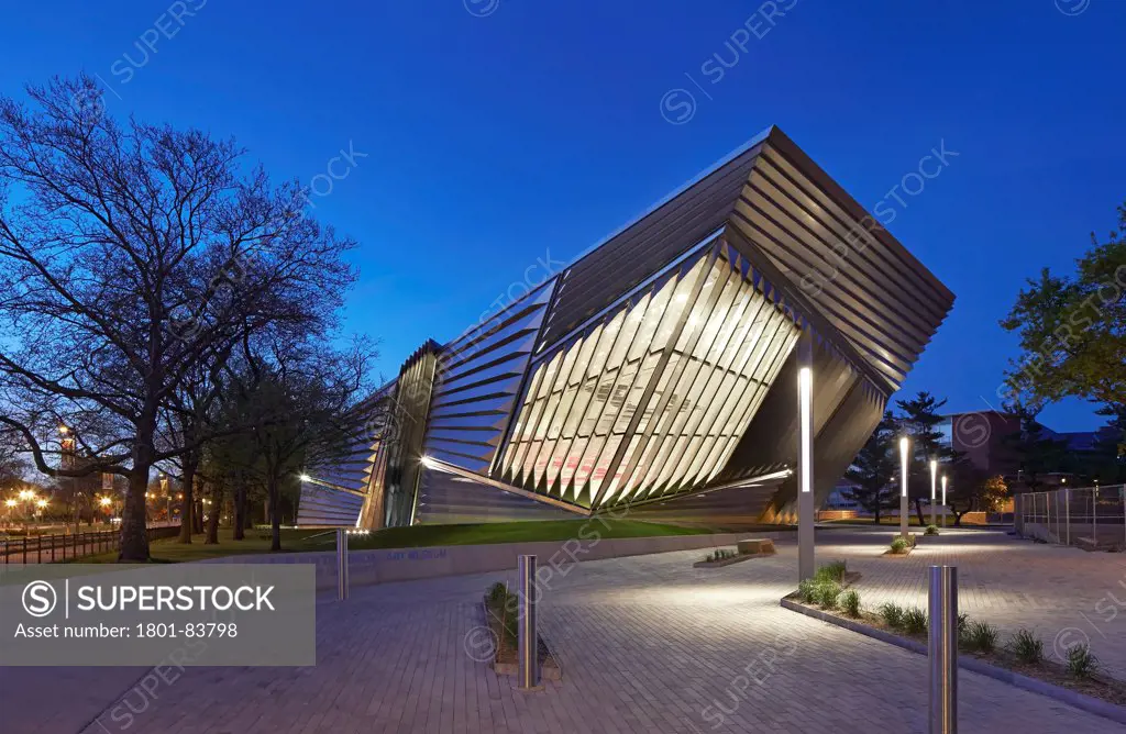 Eli & Edythe Broad Art Museum, Lansing, United States. Architect Zaha Hadid Architects, 2013. Dusk elevation of illuminated building.
