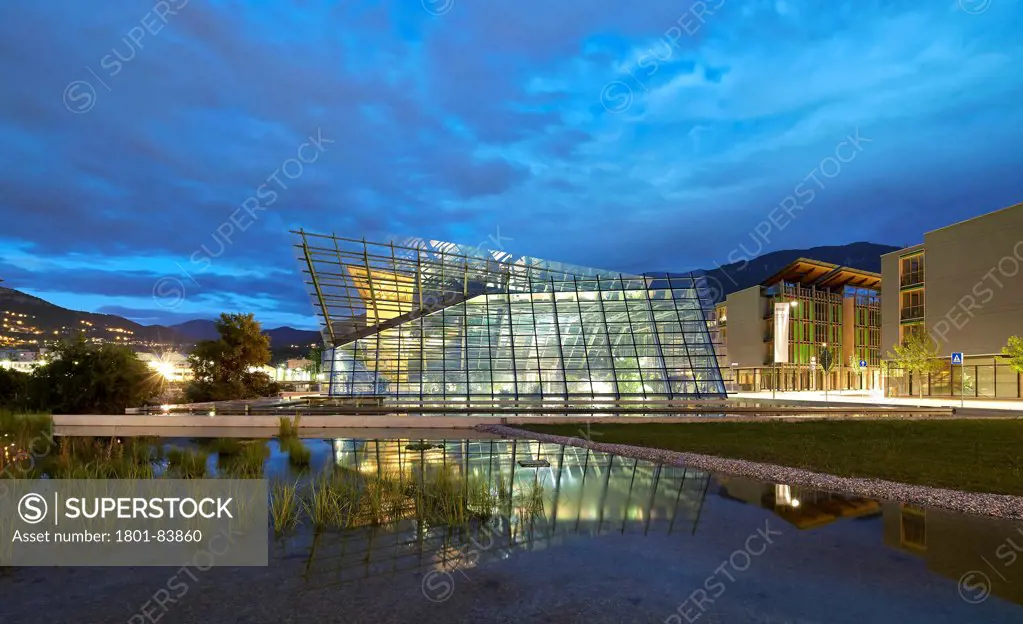 MUSEScience Museum, Trentino, Italy. Architect Renzo Piano Building Workshop, 2013. Dusk elevation with water reflection.