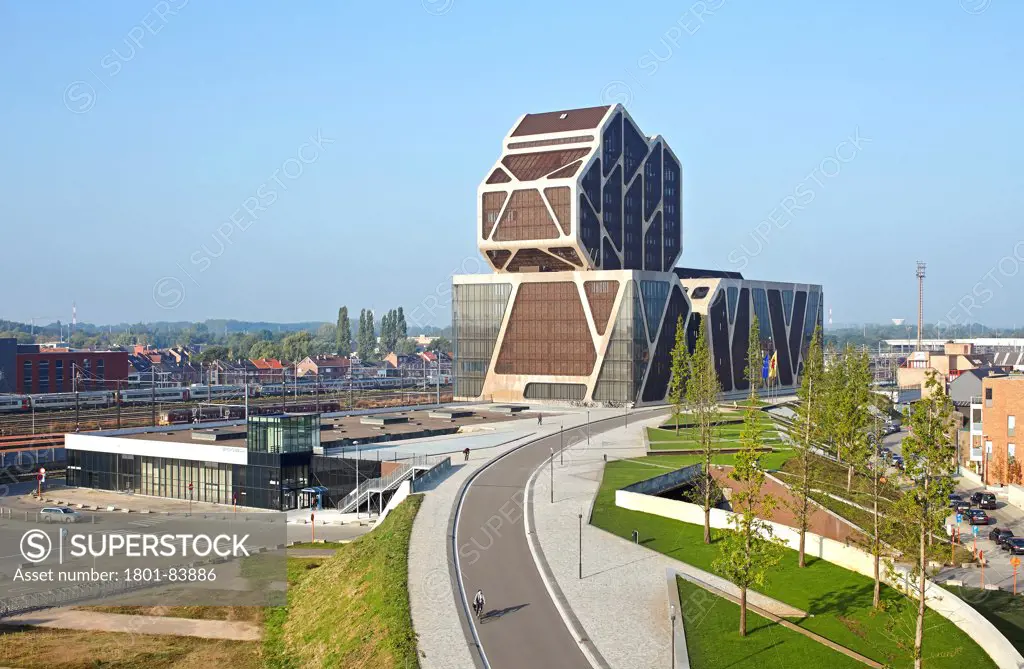 Court of Justice, Hasselt, Belgium. ArchitectJ. Mayer H. Architects, 2013. Elevated view with street, landscaped park, railway site and city.