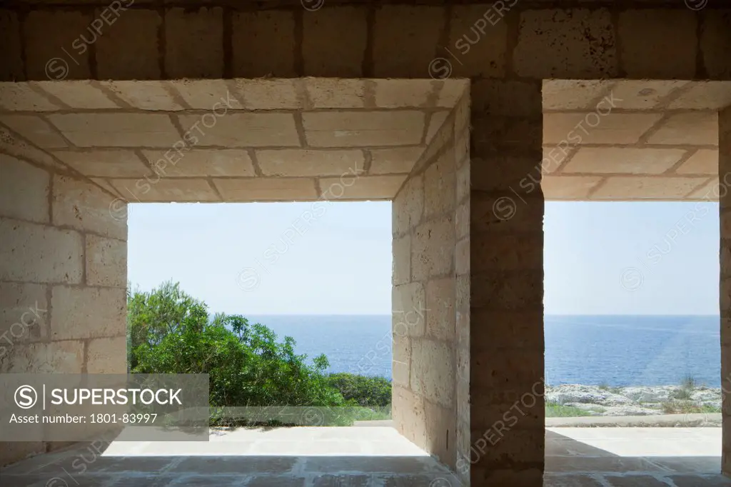 Can Lis, Mallorca, Spain. Architect Utzon, Jorn, 1971. Living Room with 'frameless' windows andview of sea.