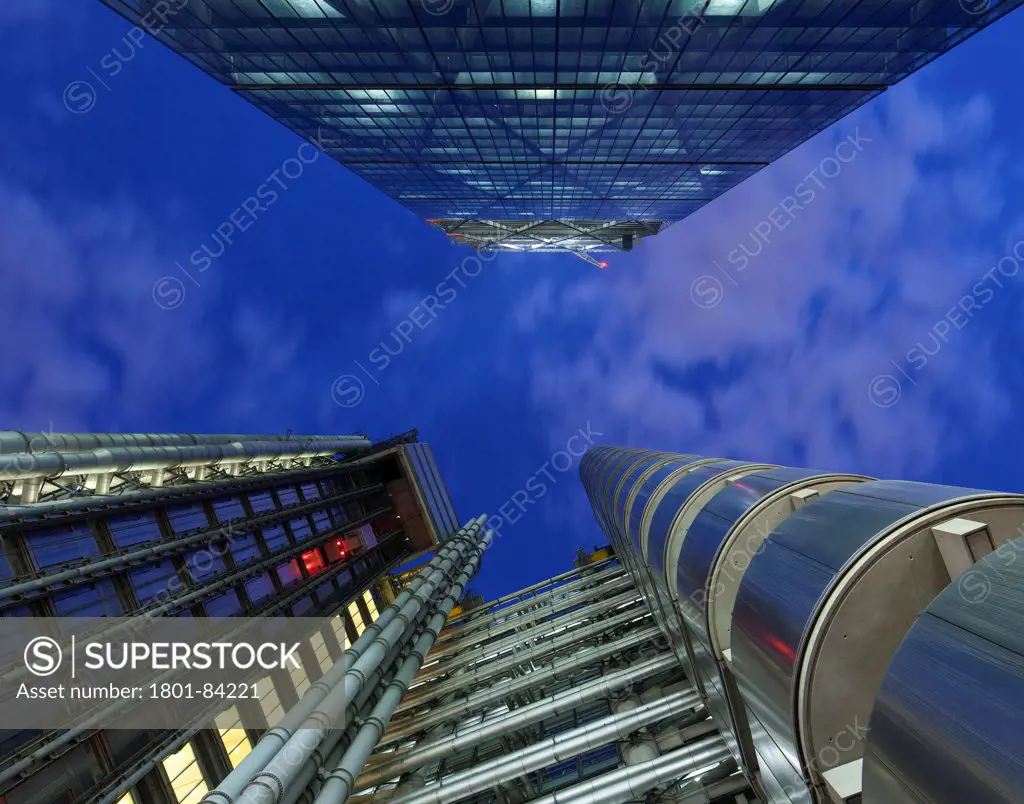 The Leadenhall Building, under construction, London, United Kingdom. Architect Rogers Stirk Harbour + Partners, 2013. Dramatic night view looking up at 'the Cheesegrater' with the Lloyds build below.