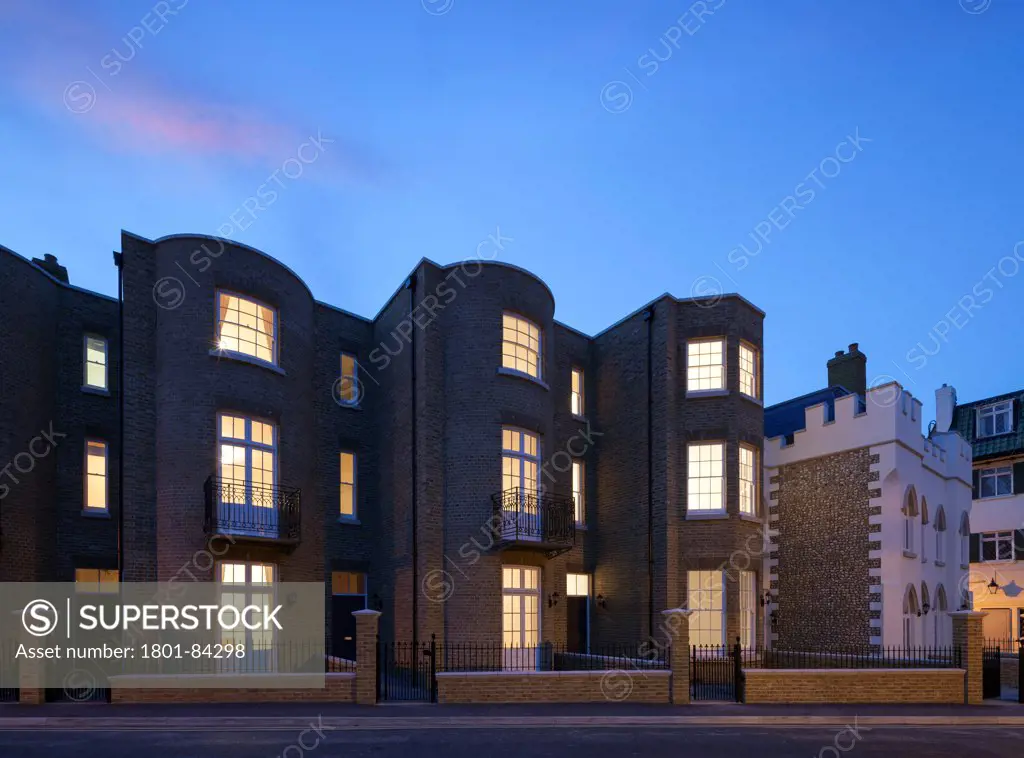 Royal Harbour View, Ramsgate, United Kingdom. Architect Madigan Browne Architects, 2013. View of streetat dusk showing mixed new build housing in a Georgian and Victorian pastiche style.