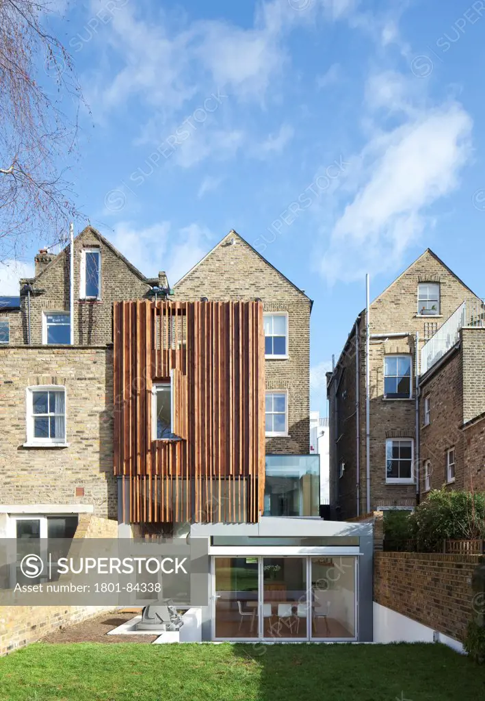 Power House, London, United Kingdom. Architect Paul Archer Design, 2013. View from the gardenshowing thesculptural timber clad rear extension.