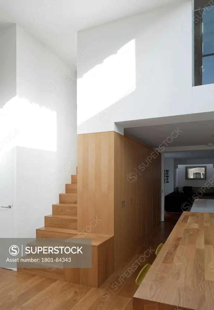 Power House, London, United Kingdom. Architect Paul Archer Design, 2013. Staircase leading out of the extension up into the main house. linear timber panels juxtaposed with white walls.