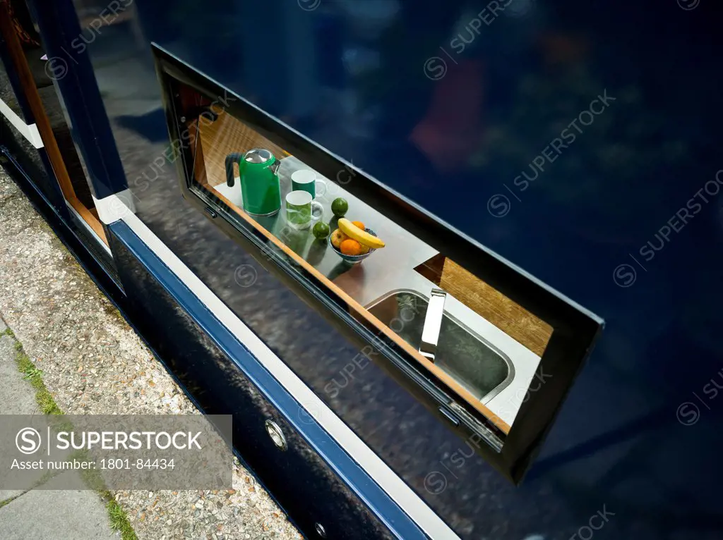 Narrowboat, London, United Kingdom. Architect Pete Young, 2013. Detail of view into kitchen through quayside window.