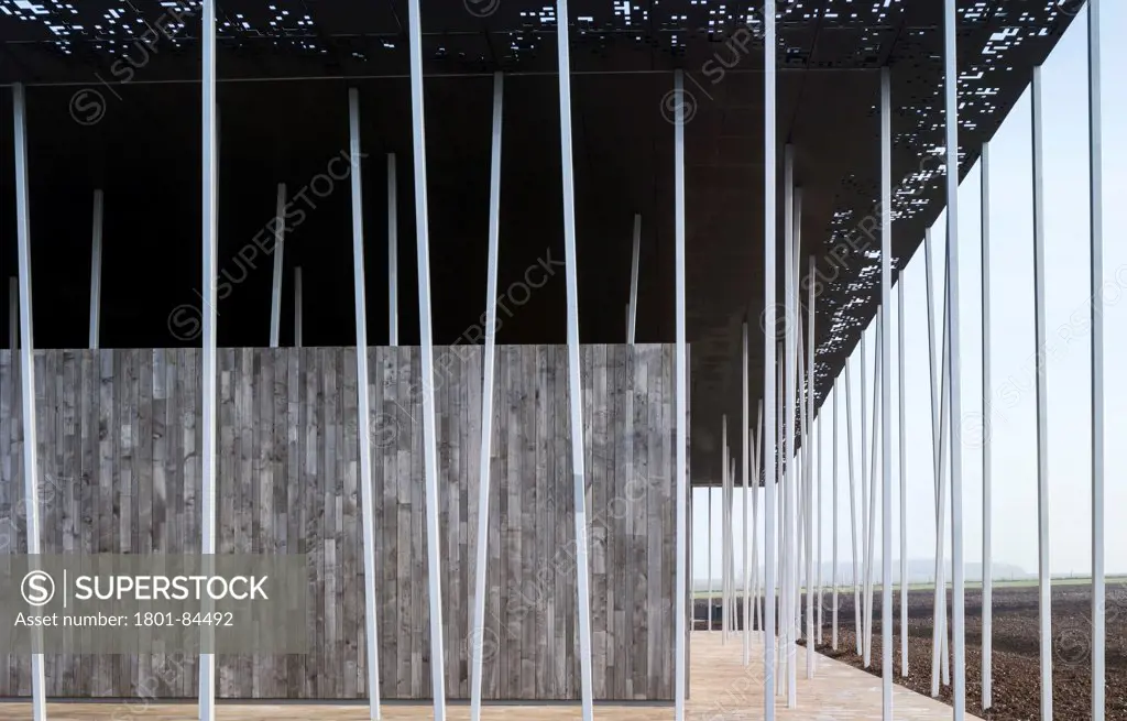 Stonehenge Visitor Centre, Amesbury, United Kingdom. Architect Denton Corker Marshall LLP, 2013. Detail of the end of the west elevation with stone walkway.