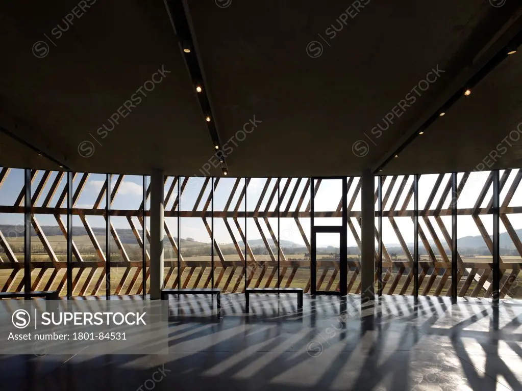 Alesia Museum, Alise-Sainte-Reine, France. Architect Bernard Tschumi Architects, 2012. View through wooden herringbone facade to surrounding landscape.