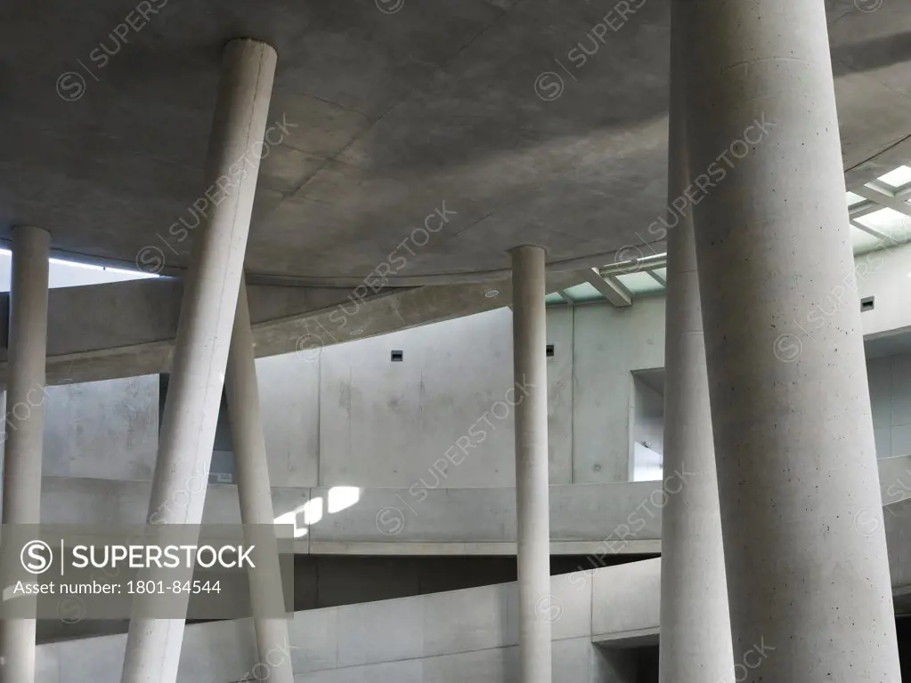 Alesia Museum, Alise-Sainte-Reine, France. Architect Bernard Tschumi Architects, 2012. Detail of concrete interior with columns and ramp.