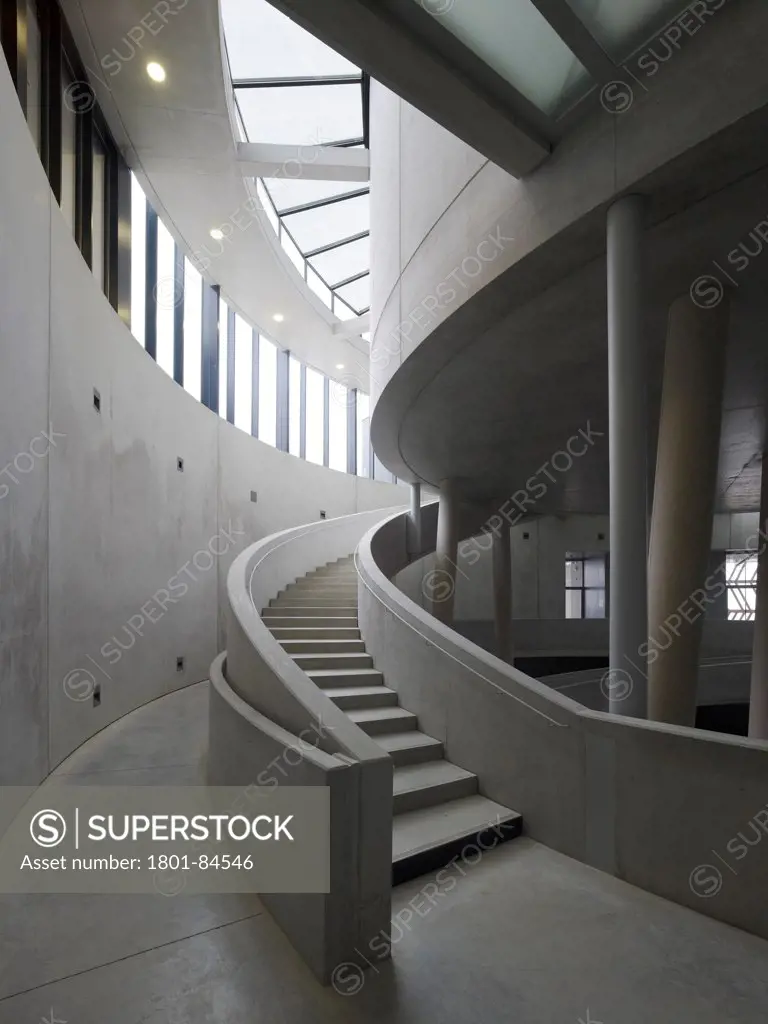 Alesia Museum, Alise-Sainte-Reine, France. Architect Bernard Tschumi Architects, 2012. Curved concrete stairway with clerestory and skylight.