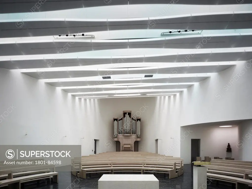 Kirche am Meer / Church by the Sea, Schillig, Germany. Architect Koenigs Architekten, 2012. View from altar towards pews and church organ.