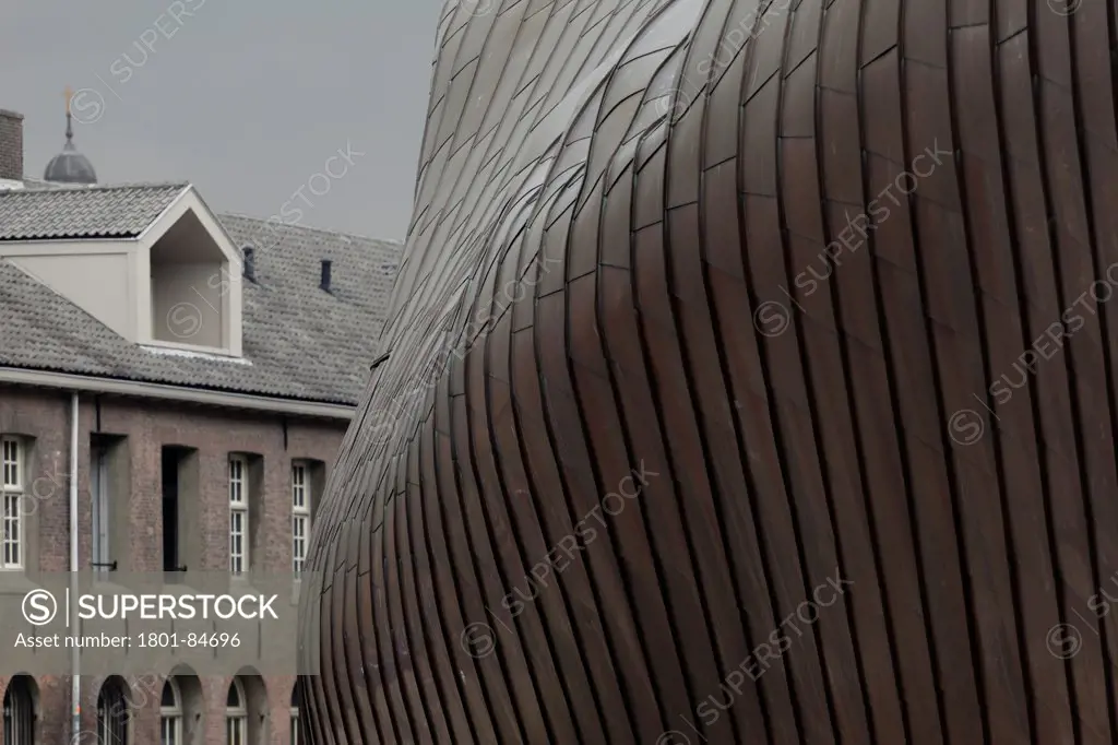 Detail of ribbed pre-oxidised copper exterior with traditional buildings in background, Popstage Mezz, Breda, The Netherlands (architect Erick van Egeraat, 2002)