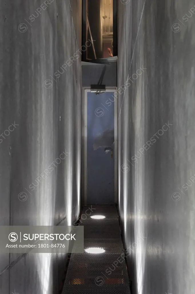 Internal passage with uplit concrete walls