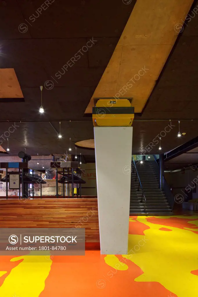 View of basement entrance foyer with orange and yelow patterned flooring