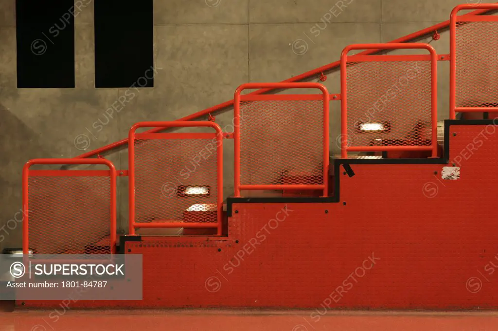 Red metal staircase against concrete wall in Kleine Zaal (Small Hall)