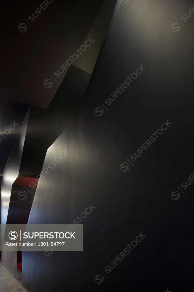 Staircase fissure in black wall with reflections