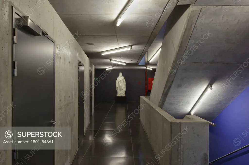 Fourth floor with concrete staircase and walls and historic statue