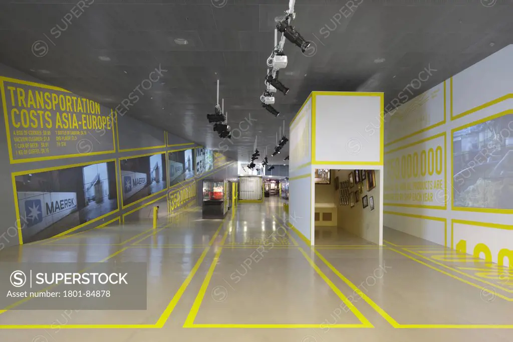 Main exhibition hall with containers and yellow wall and floor graphics