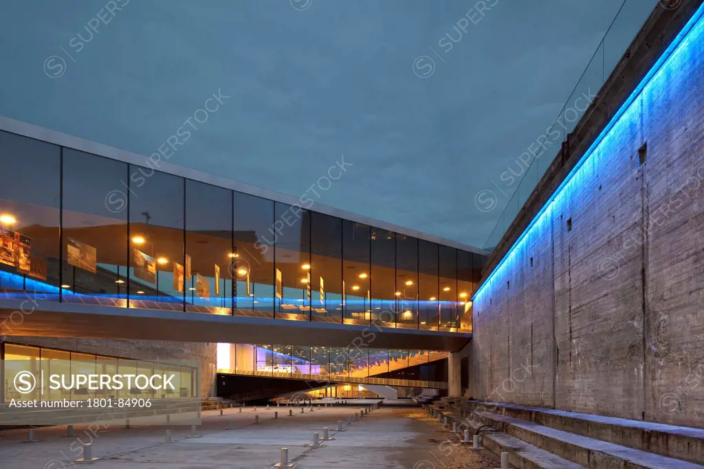 Exterior with lit sloping walkways against cloudy sky at dusk