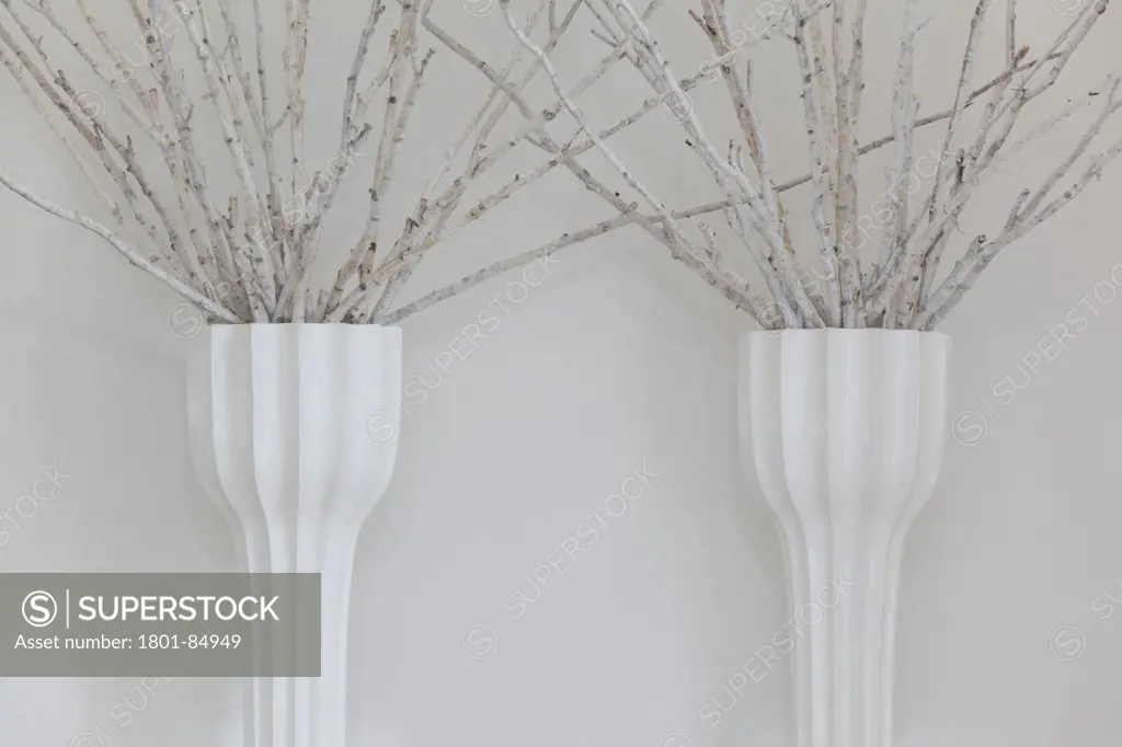 White vases against white wall in reception