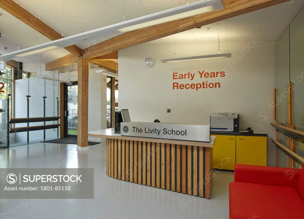 The Livity School, London, United Kingdom. Architect Haverstock Associates LLP, 2013. Reception foyer and desk.